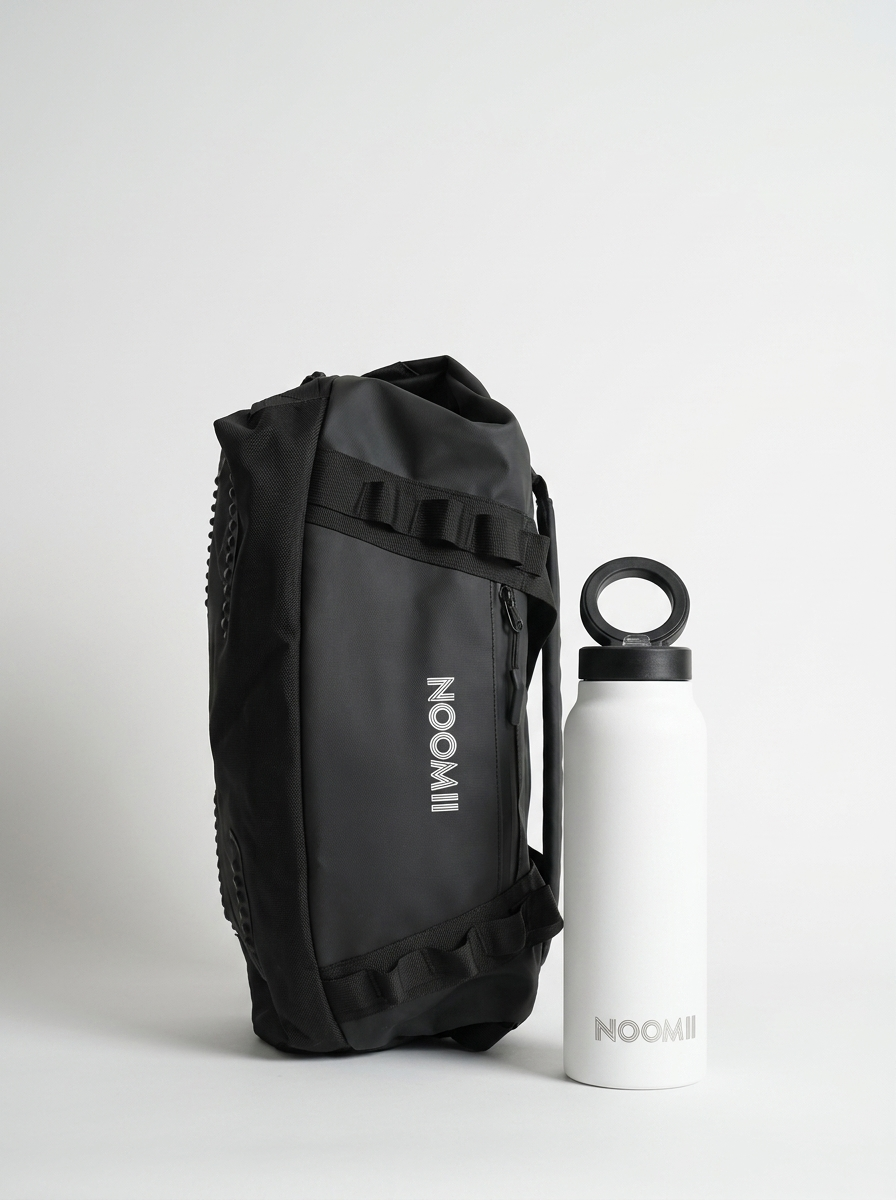 NooMii 2-in-1 gym bag and insulated bottle on a light grey studio background